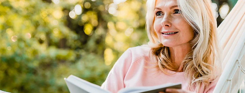 Woman enjoying a book without reading glasses